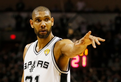 Spurs' Duncan points to the bench during a break in play against the Heat during Game 3 of their NBA Finals basketball playoff in San Antonio